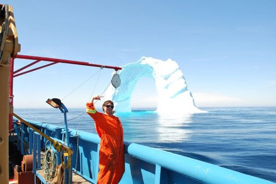 iceberg archway in the middle of the ocean