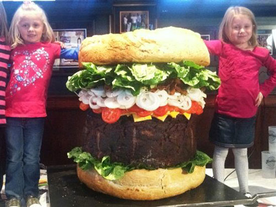two girls with a 338 lb burger
